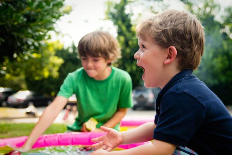 Two young boys playing outside in the garden