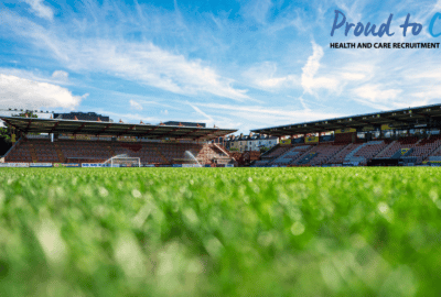 Exeter City Football Club's ground in Exeter, with a Proud to Care logo
