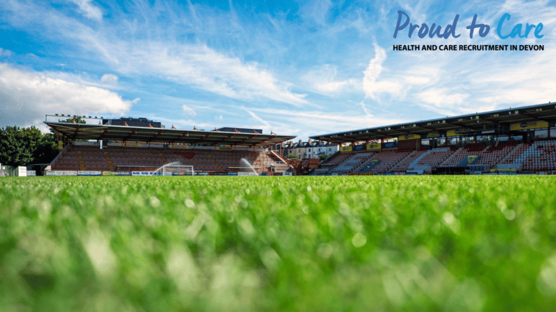 Exeter City Football Club's ground in Exeter, with a Proud to Care logo