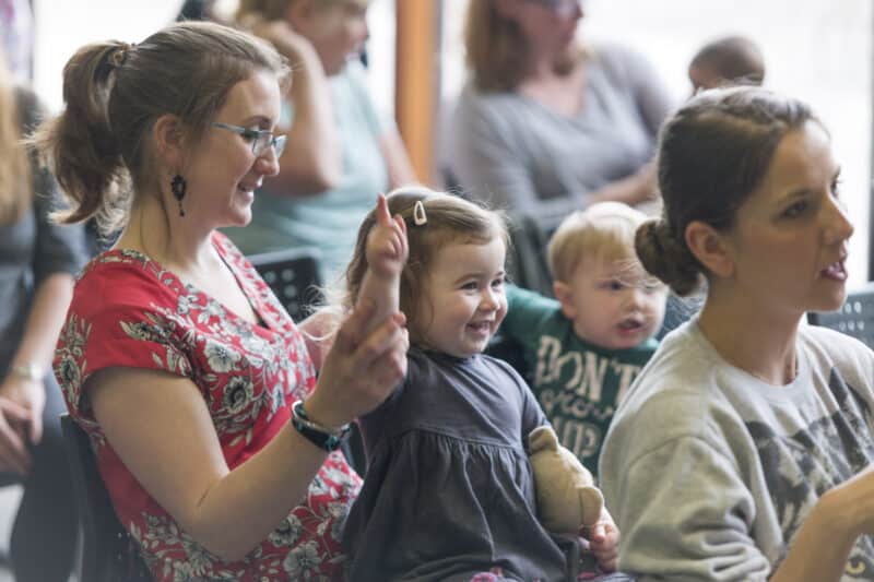 mother and young child enjoying themselves at a library