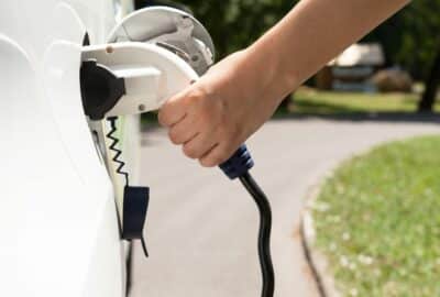 An electric vehicle, plugged in, charging