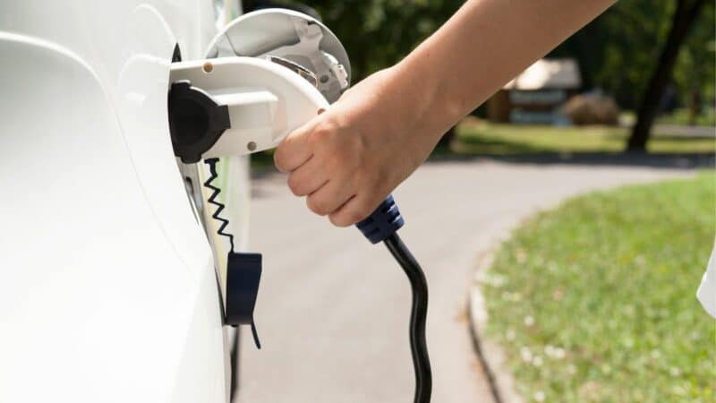 An electric vehicle, plugged in, charging