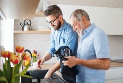 Young man helping elderly man