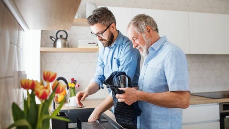 Young man helping elderly man