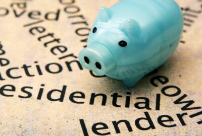 A piggy bank on a piece of paper that has the word 'lender' typed on it