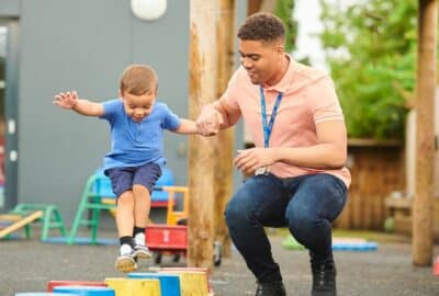 A young boy playing outside at pre-school