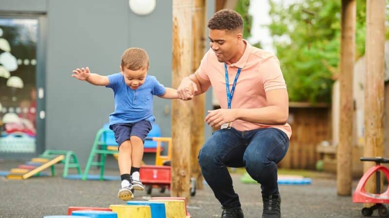 A young boy playing outside at pre-school