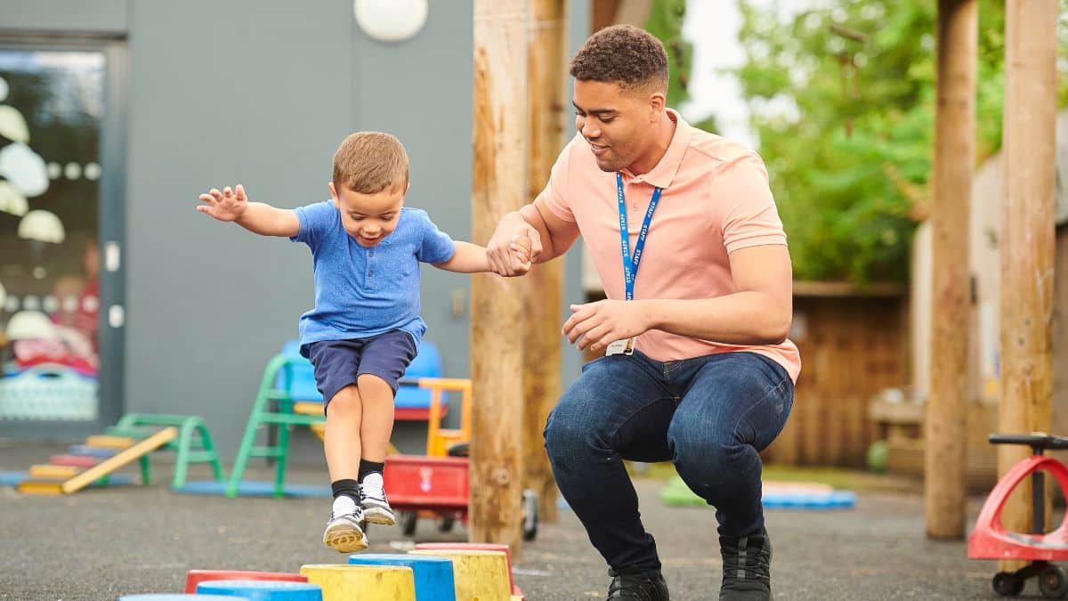 A young boy playing outside at pre-school
