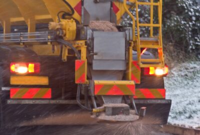 A gritting lorry spreading grit