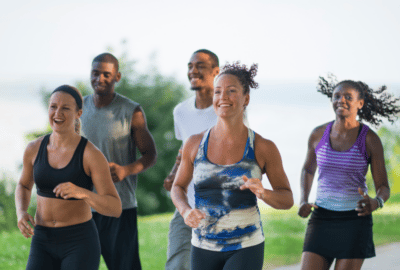 A group of people out jogging in a park