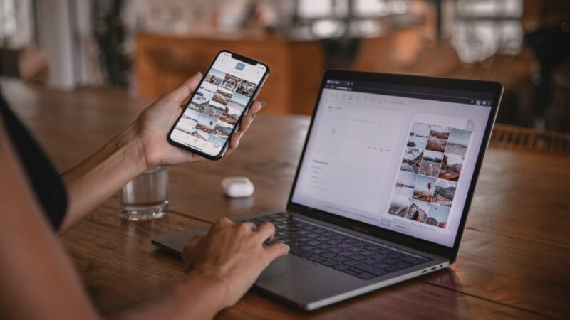 Person sat with a phone and laptop