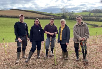 Councillor Andrea Davis (Cabinet Member for Climate Change and Environment) plants a tree with others from Devon County Council, Woodland Trust and ParkLife South West