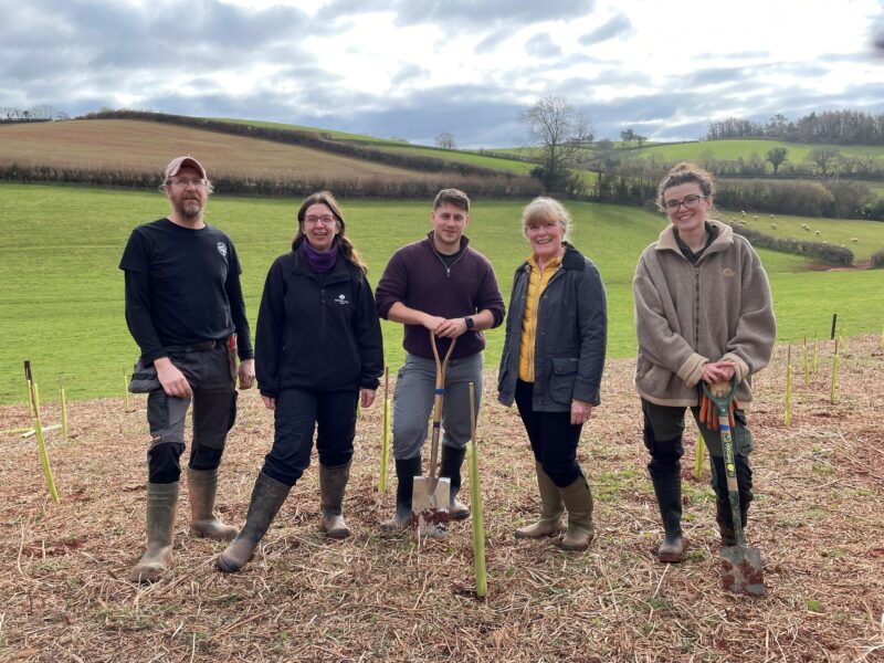 Councillor Andrea Davis (Cabinet Member for Climate Change and Environment) plants a tree with others from Devon County Council, Woodland Trust and ParkLife South West