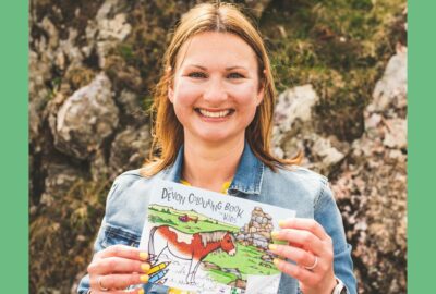 Claire Hall holding her colouring books