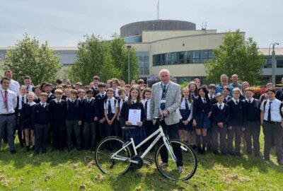 Beatrice Stothert, the 100,000th Bikeability trainee in Devon receives a bike and certificate from Councillor Stuart Hughes