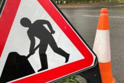 Road works sign and bollard