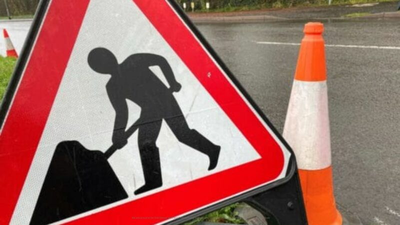 Road works sign and bollard