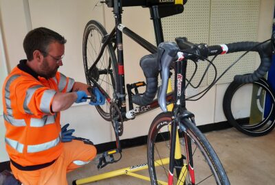 Sues employee repairing a bike