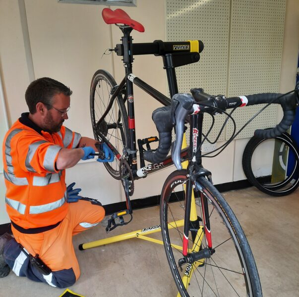 Sues employee repairing a bike