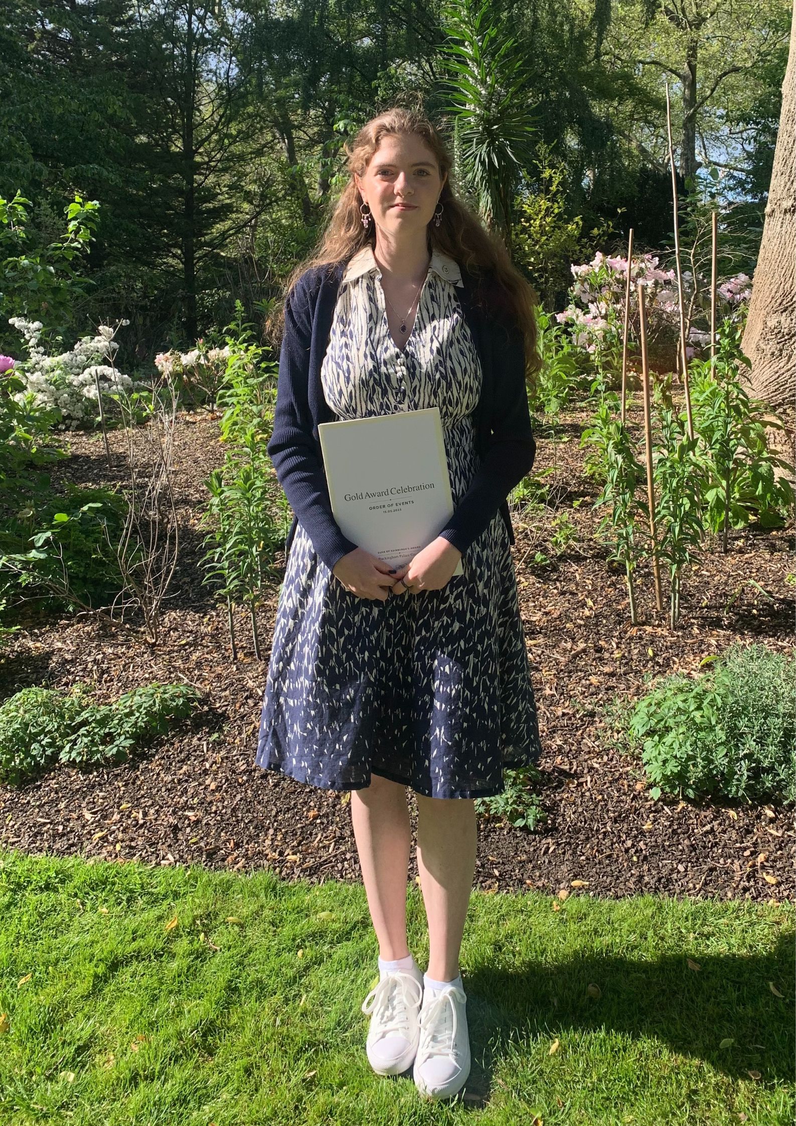 Keira, stood in a garden holding her DoE Gold Award