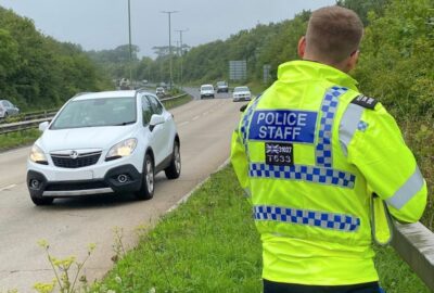 Police officer using speed detection equipment