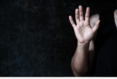 A woman holding up her hand, palm outstretched