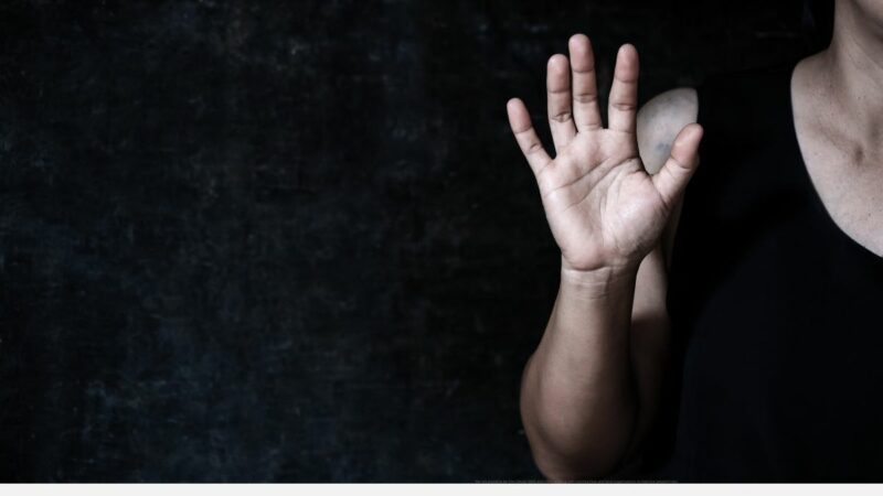A woman holding up her hand, palm outstretched
