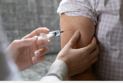 A person receiving their vaccination in their upper arm