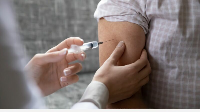 A person receiving their vaccination in their upper arm
