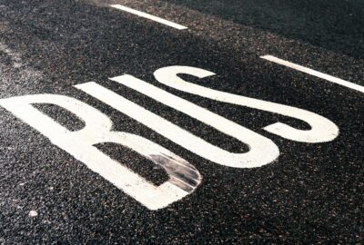 The word 'bus' on a road, indicating a bus lane.