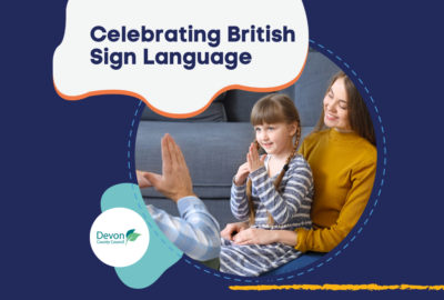 Photo of a young girl using British Sign Language with her parents. Text reads 'Celebrating British Sign Language'