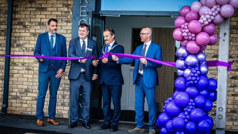 The Chairman of Devon County Council, right of middle, and local MP, left of middle, at the opening of the new school