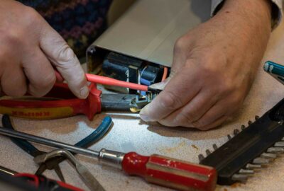 Hands fixing electrical equipment