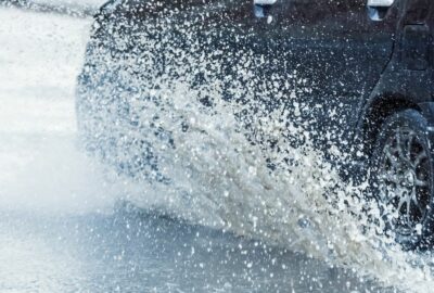 moving car with water splashing up from the wheels
