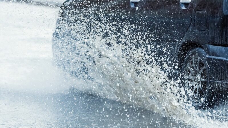 moving car with water splashing up from the wheels