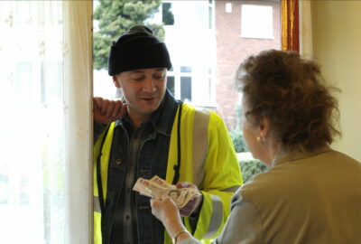 Elderly lady paying rogue tradesman