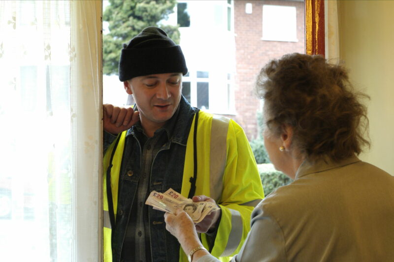 Elderly lady paying rogue tradesman