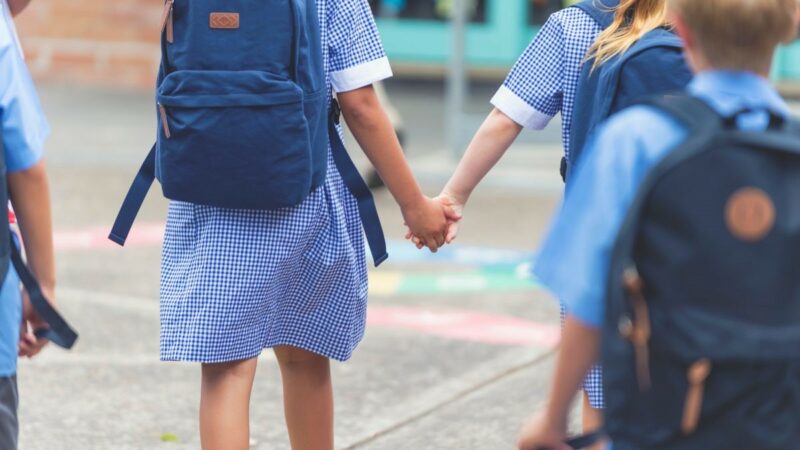 School children holding hands