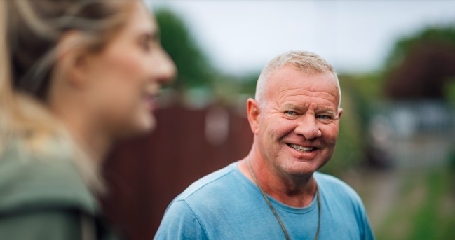 A middle age man smiling