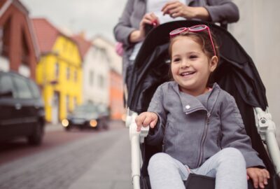 A young child being pushed in a pushchair