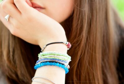 Close up photo of a teenage girl. Only her hand on her chin is in view