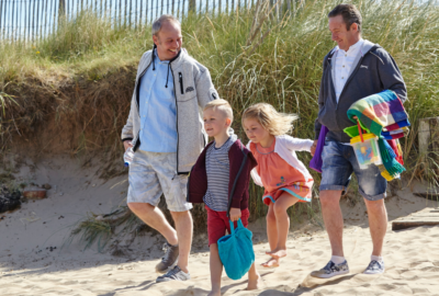 A couple on the beach with their adopted children