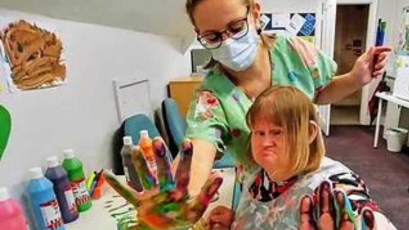 A member of the team at Northam Care Trust working with and supporting one of their residents