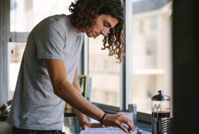 A young adult at home in the kitchen