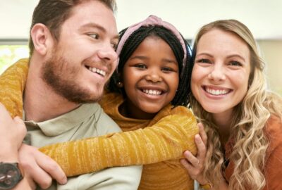 Foster mother and father with fostered child