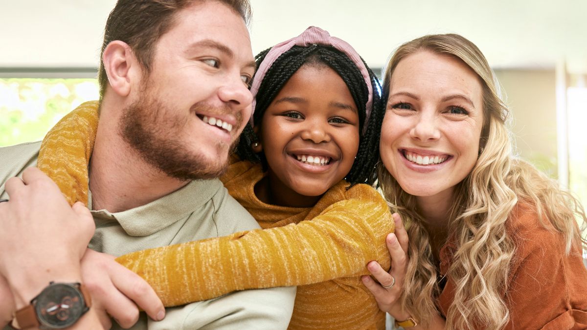 Foster mother and father with fostered child