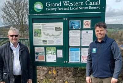 Ray Alexander (IWA) and Mark Baker (Grand Western Canal Country Park Manager) beside one of the new noticeboards
