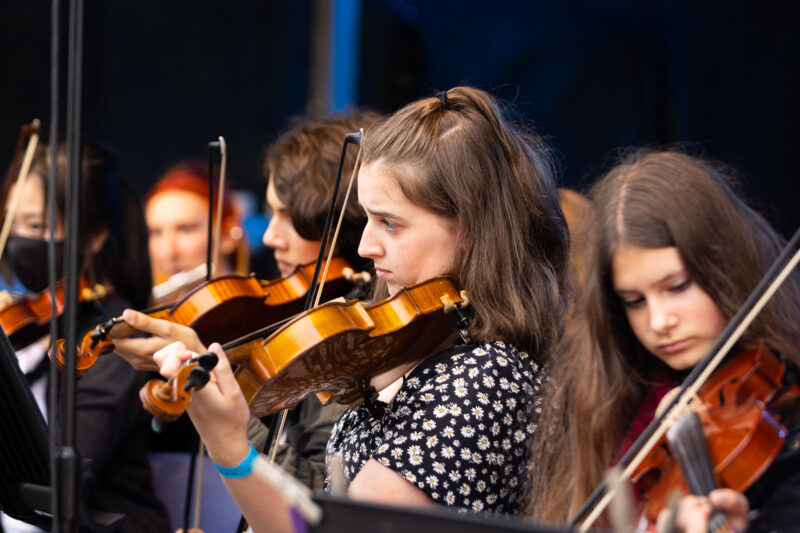 Children playing brass and string instruments