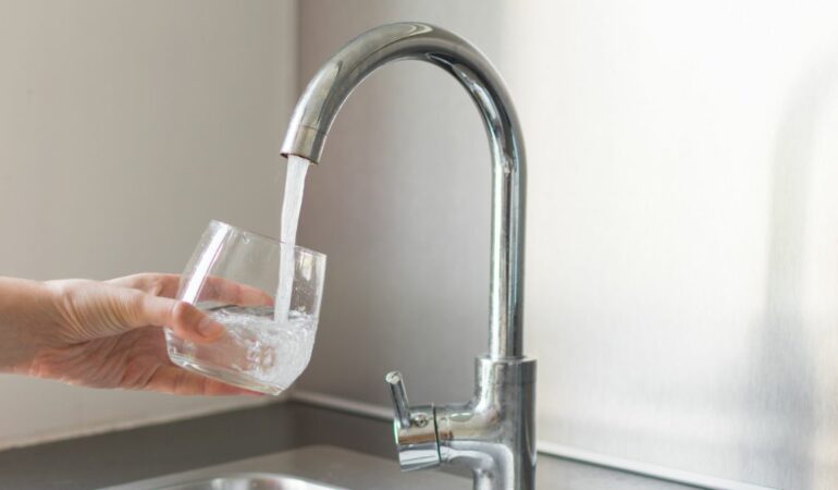 Filling a glass of water from the tap