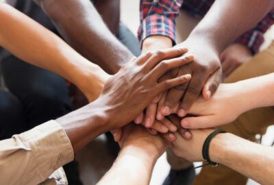 Hands on top of each other in a circle